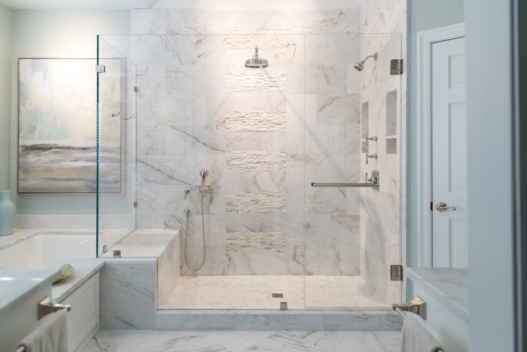 Large seamless shower with nickel hardware and a traditional swinging door.