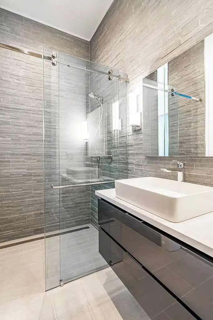 Barn door and exposed rollers on a shower.