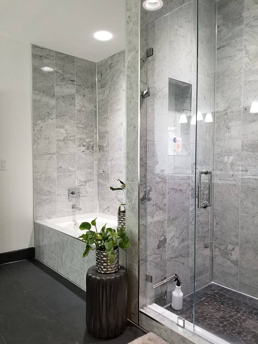 Tall shower glass with silver hardware.