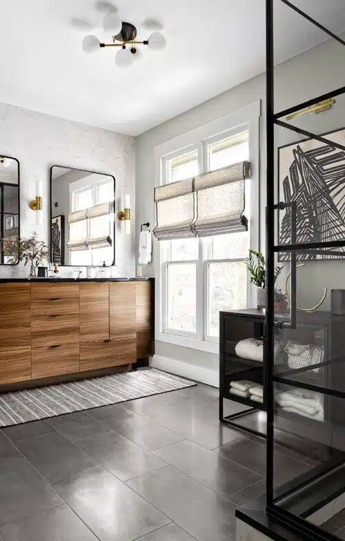 Mirrors over a double sink. The mirrors have a curved edge with black accents.