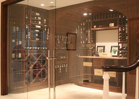 Glass window and door enclosing a residential wine cellar.