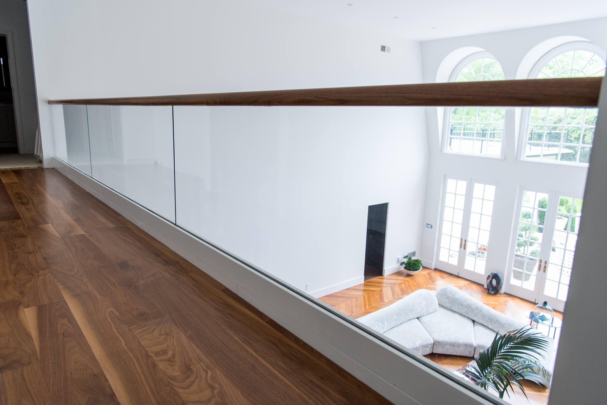 Glass railing for a balcony overlooking the living area.