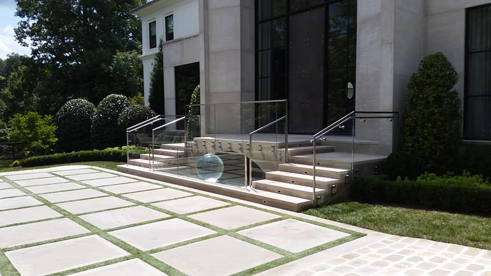 Outdoor glass railing with handrails for the front entryway.