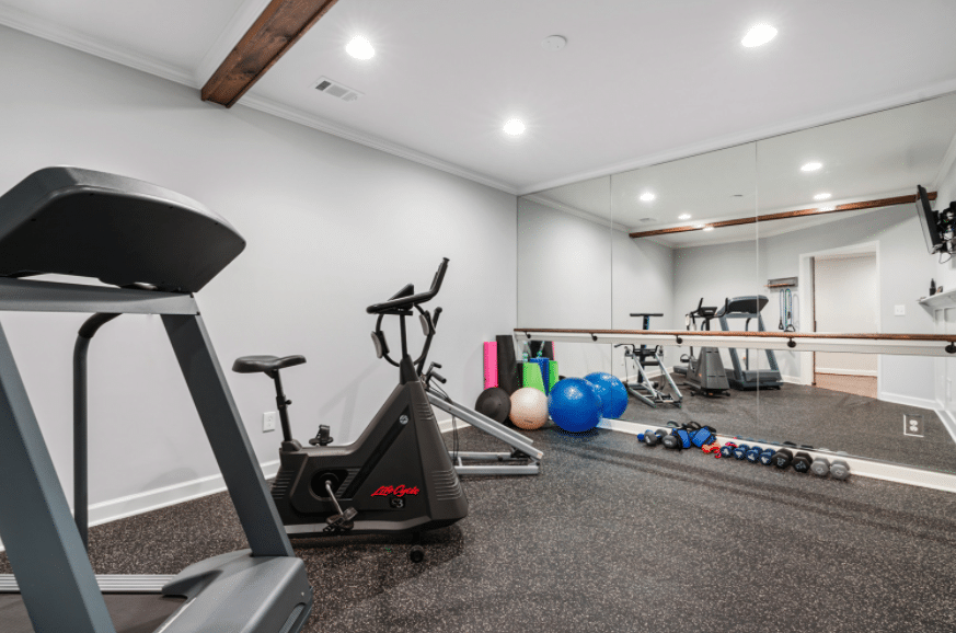 gym area with large mirror covering entire wall