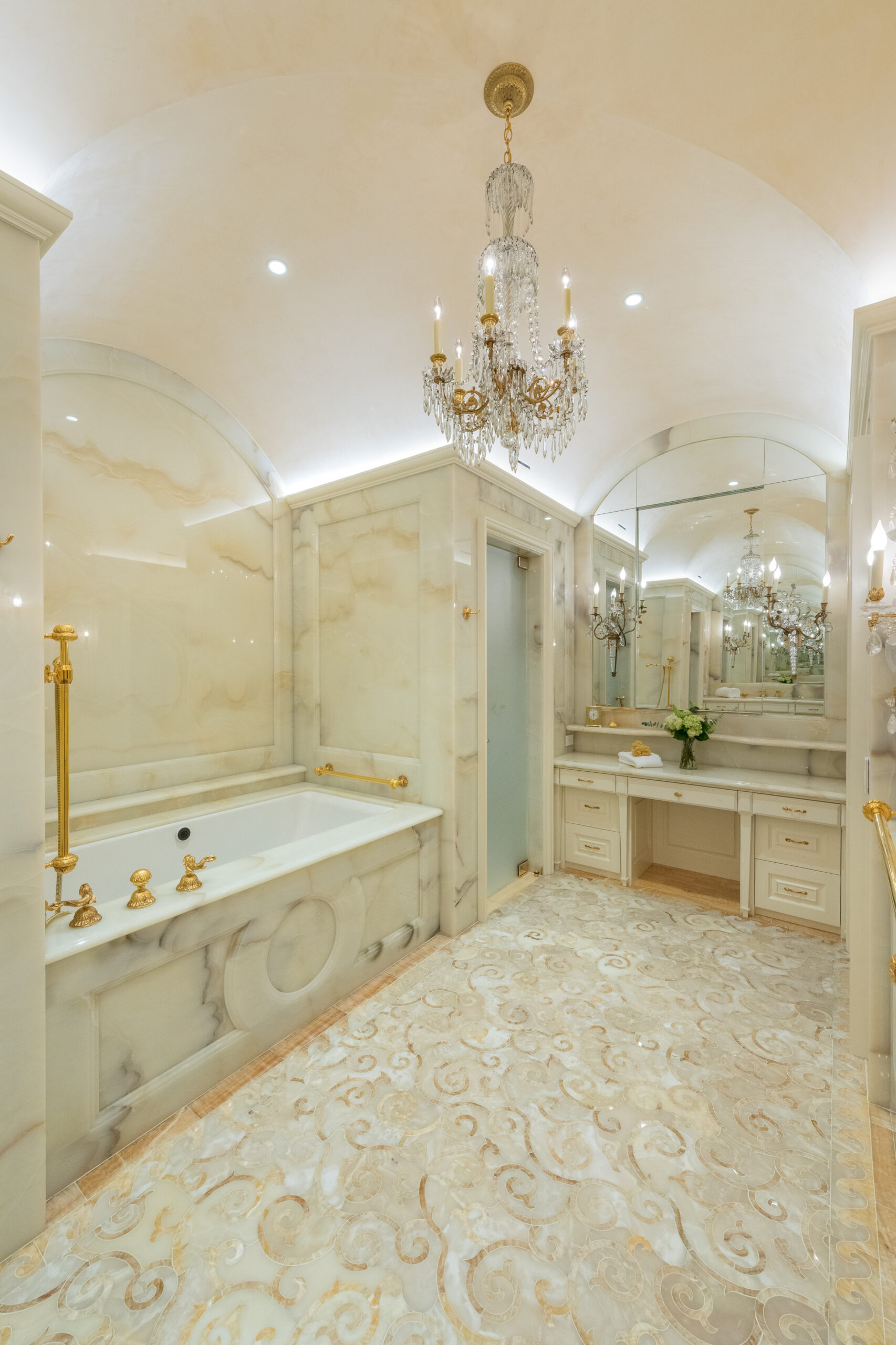 Elegant marble bathroom with glass accents.