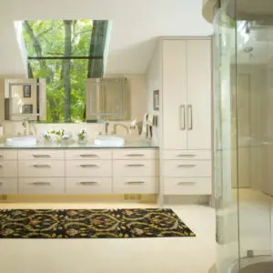 Bathroom with rounded glass shower doors, glass countertops, mirrors and a large window