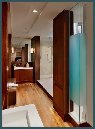 Glass featured throughout the bathroom around the shower and vanity areas