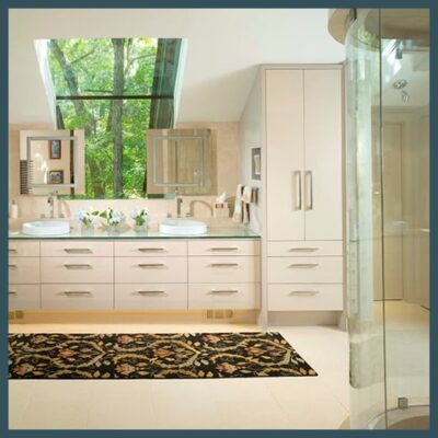 Bathroom with rounded glass shower doors, glass countertops, mirrors and a large window