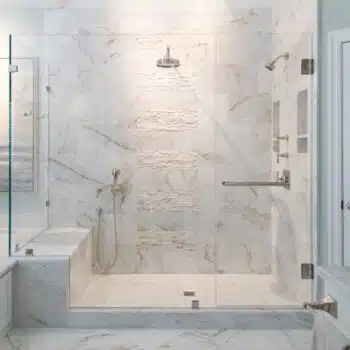 Large seamless shower with nickel hardware and a traditional swinging door.